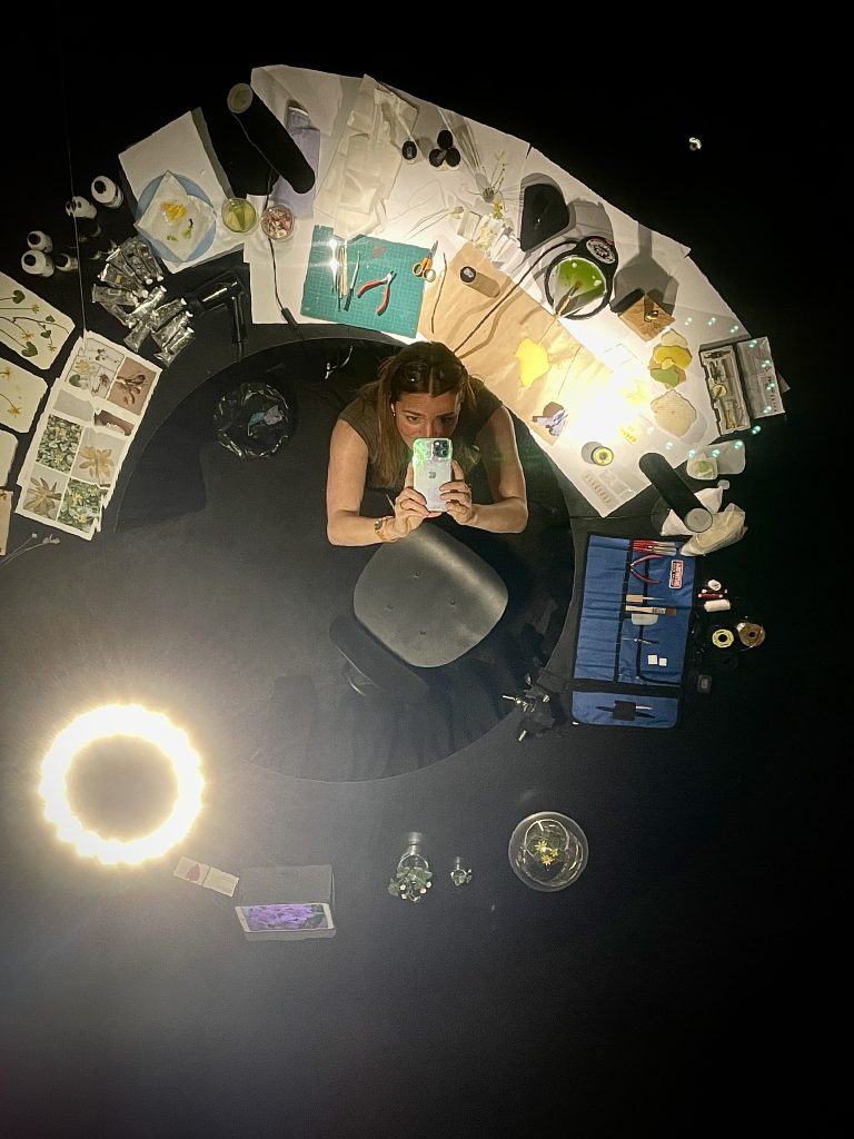 Overhead view of tools, reference materials and wax botanical sculpture in progress during a live demonstration at Homo Faber 2022.