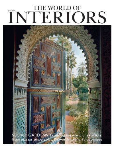 Front cover of the World of Interiors magazine showing a decorative arched doorway leading to a garden.