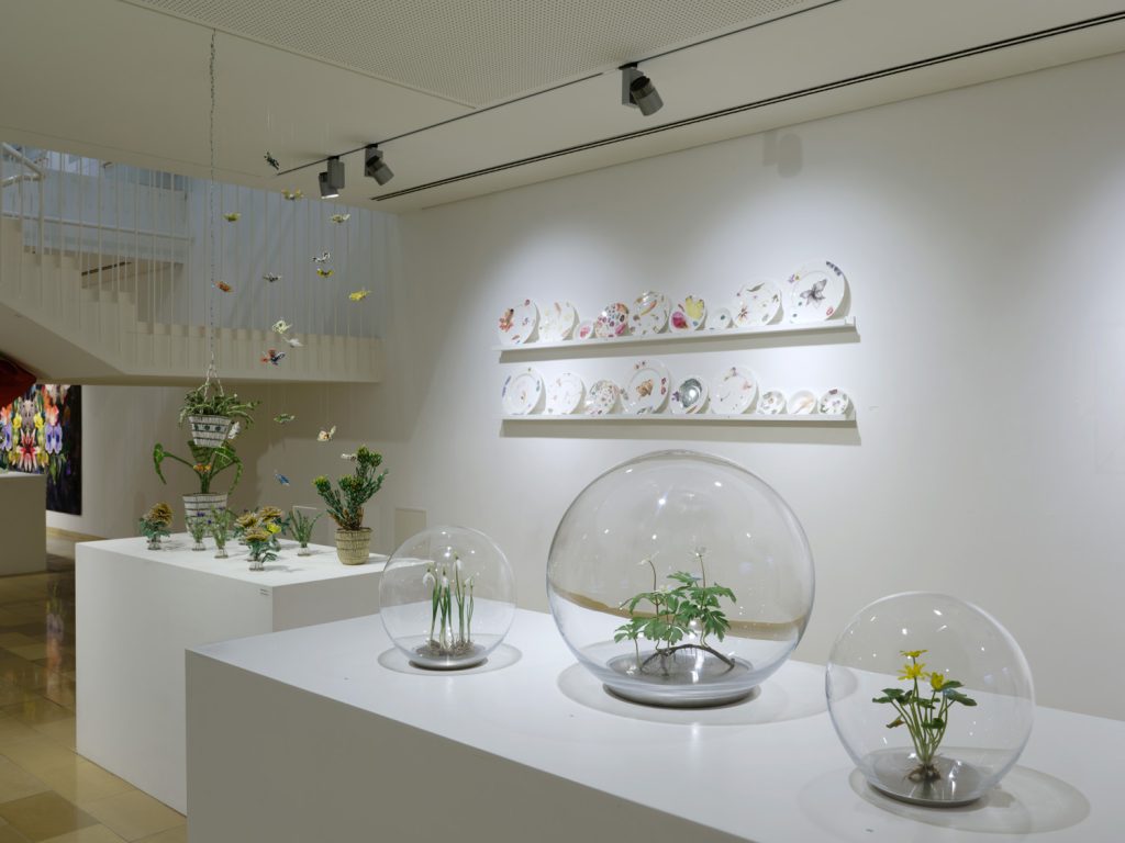Installation view of Blütenpracht at Galerie Handwerk, Munich, featuring Snowdrops, Celandine and Wood Anemone from Annette Marie Townsend's Life Support series displayed within hand-blown glass orbs.