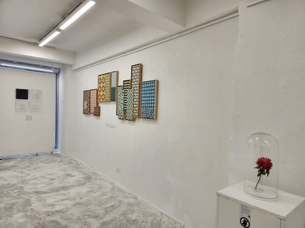 Installation view of Defying Boundaries: Female Vision at Karin Weber Gallery, Hong Kong, showing Autumn Chrysanthemum displayed beneath a glass dome alongside works from the Flight of the Bumblebees series and other gallery artists.