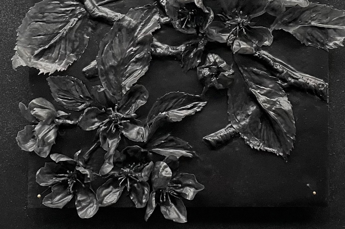 Close-up detail of black wax apple blossom sculpture from Flight of the Bumblebees series